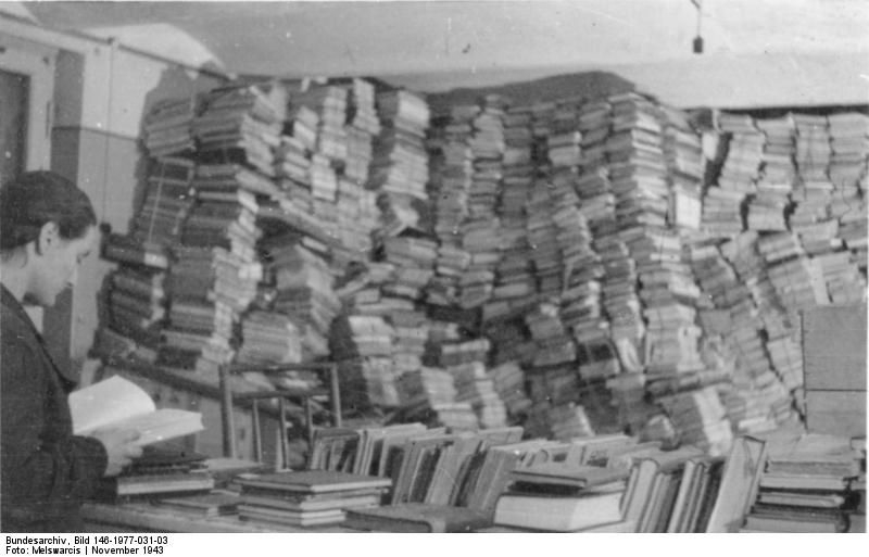 Ein Bücherlager in der Dienststelle des Einsatzstabes in Riga (Lettland), November 1943, Bundesarchiv Bild 146-1977-031-03, Wikimedia Commons, CC BY-SA 3.0.