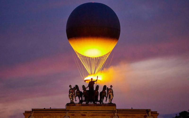 The Cauldron With The Olympic Flame Lit Flies Seen From The Louvre