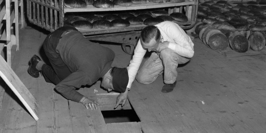 U.S. federal government, U.S. Lt. Robert R, Rogers, left, and Erich Pinkau, of the German criminal police, inspect the bakery and the hiding place of Leipke Distel, a member of Jewish revenge group Nakam, who had tried to poison loaves of bread for SS prisoners, 1946