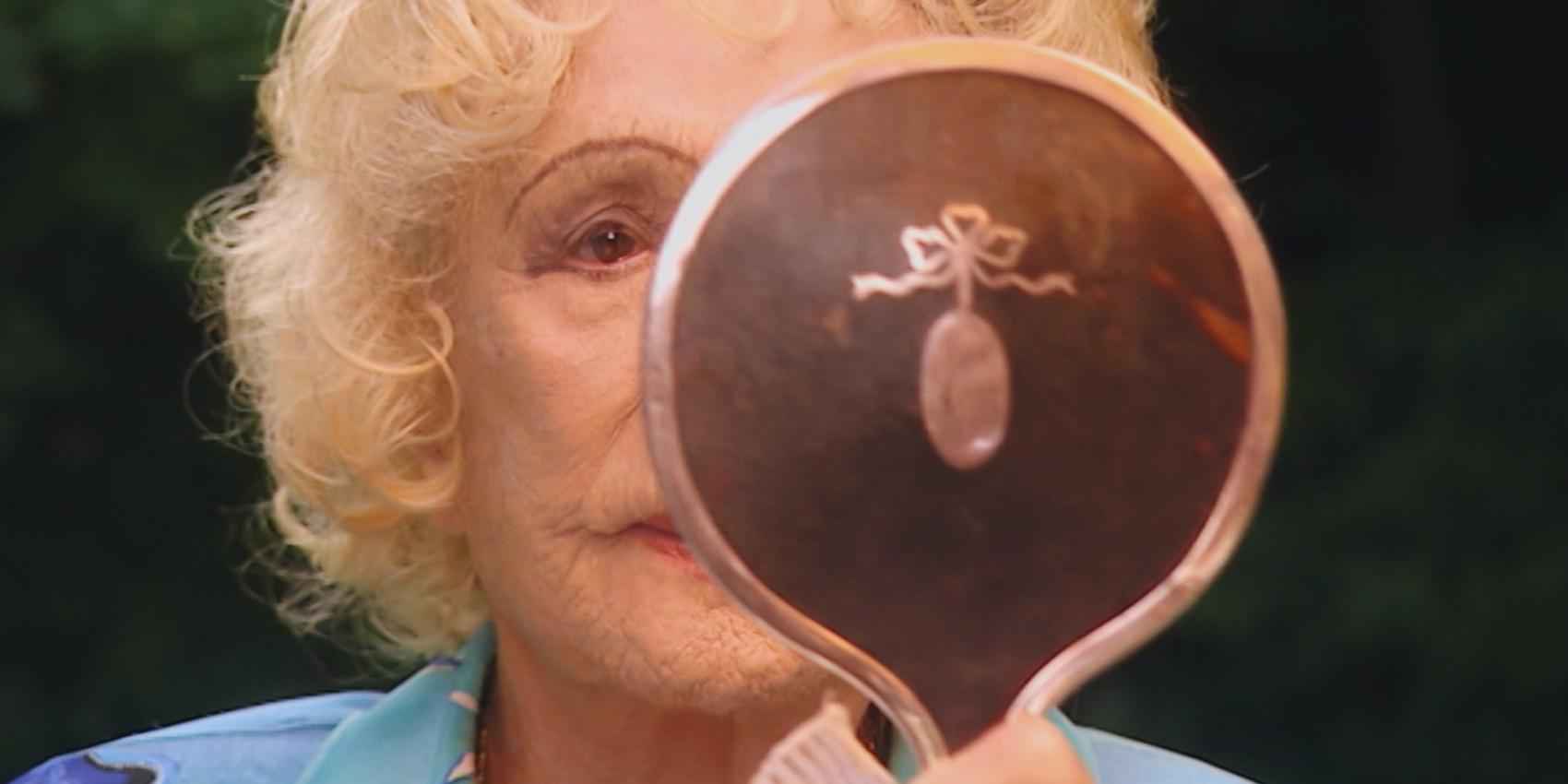 Leni Riefenstahl kontrolliert ihr Aussehen für die Aufzeichnung zur dreiteiligen Dokumentation „Speer und er“ von Regisseur Heinrich Breloer (1999) (© Bavaria Media)