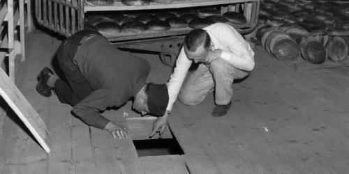 U.S. federal government, U.S. Lt. Robert R, Rogers, left, and Erich Pinkau, of the German criminal police, inspect the bakery and the hiding place of Leipke Distel, a member of Jewish revenge group Nakam, who had tried to poison loaves of bread for SS prisoners, 1946